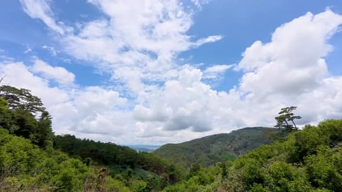 Timelapse of fluffy clouds drifting across a clear blue sky