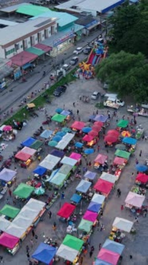 Aerial View of a Large Rural Openair Market Near the Highway Next to the Trees