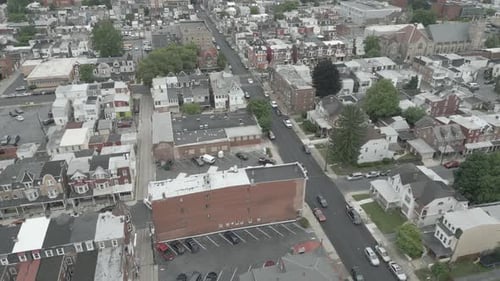 Flying over head of a small town full of buildings