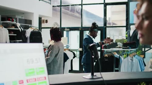 Pregnant Woman Looking at Trendy Merchandise on Stand Hangers