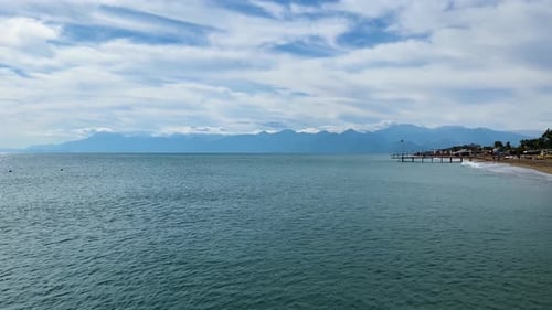 Coastal View of Calm Waters and Pier at Sunrise