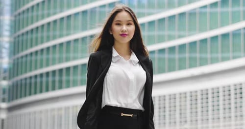 Smiling Young Businesswoman Stands Confidently Downtown