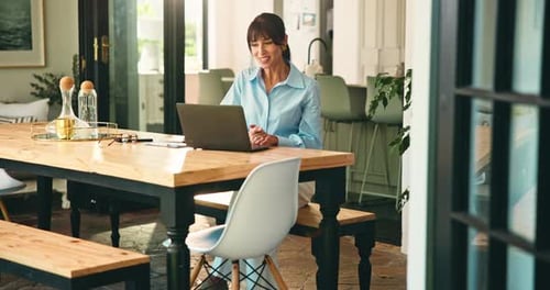 Professional Woman Working from Home on Laptop