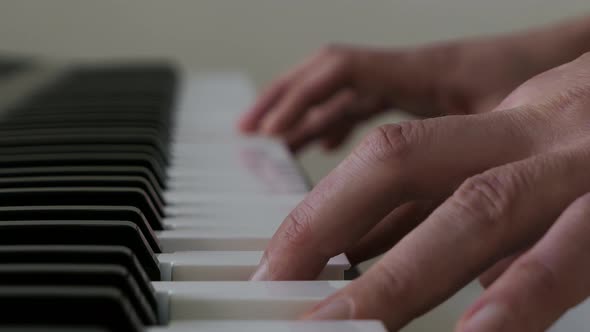 Person practicing chords on piano, practicing playing music, close up ...