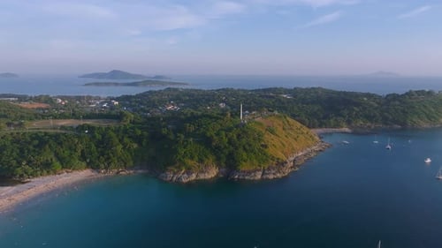 Aerial View of Phuket Island Showing a Serene Beach Lush Green Hills a Calm Blue Sea