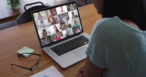 African american woman having a video conference with office colleague on laptop