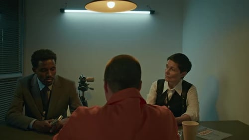 Interrogation of a Suspect in a Dimly Lit Room