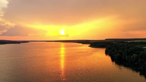 Beautiful orange sunset over the calm river.