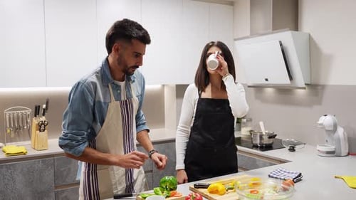 Couple Cooking and Preparing Food Together in Kitchen