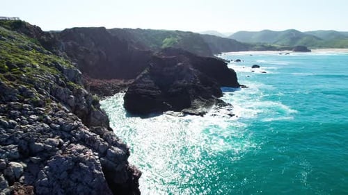 Aerial View of Rocky Coastline and Turquoise Ocean