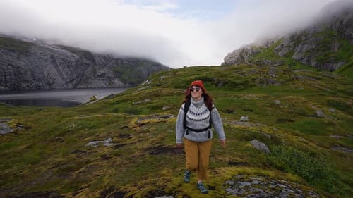Portrait Woman Traveler with Big Backpack Hiking in Lofoten Mountains with Beautiful Norway