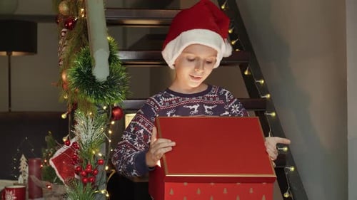 Boy Opening Magical Christmas Gift Indoors