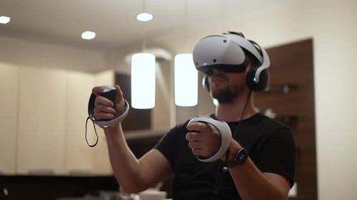 Man Uses Virtual Reality Headset at Home