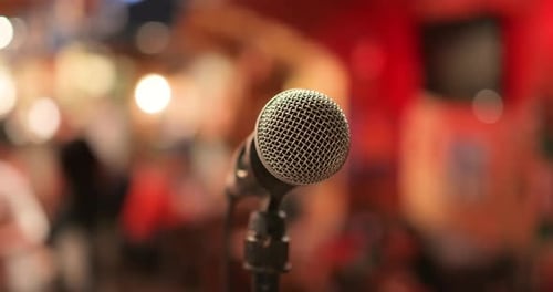 Microphone on stage against a background of auditorium.