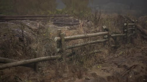 An Old Wood Fence with a Country Field Behind It