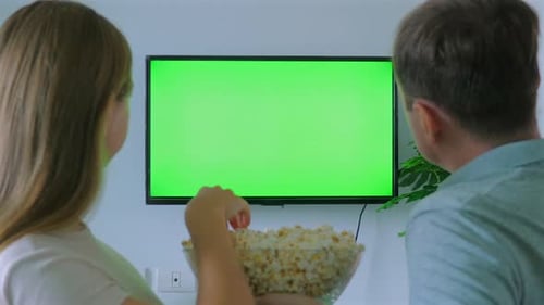 Couple Watching Green Screen TV While Eating Popcorn Perfect for
