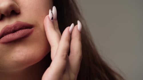 Woman Poses with Hand on Face Close Up