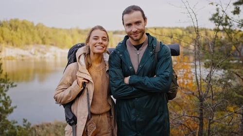 Happy Couple Backpacking Together in Nature