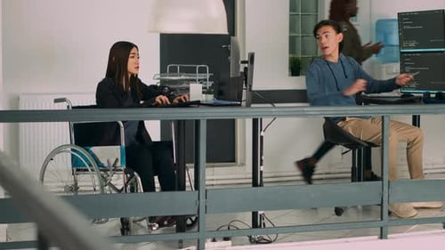 Database Programer with Physical Disability Writing Code on Computer Screen