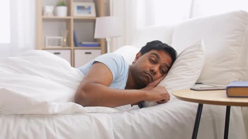 Man Sleeping in Bed Wakes Up to Phone