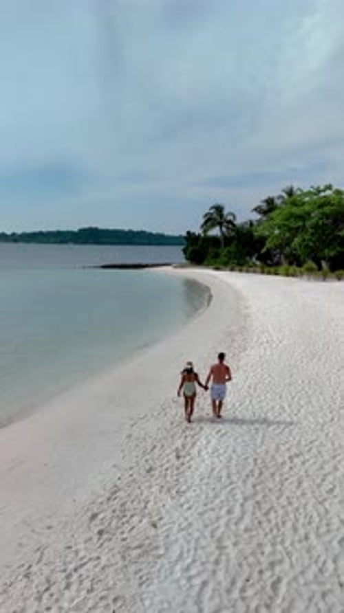 Explore the Serene Beauty of Koh Kham Island in Thailand with a Romantic Beach Stroll