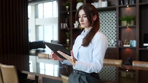 Portrait of Elegant Gorgeous Successful Businesswoman Using Tablet and Standing in Company Office