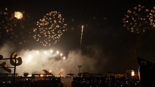 Golden Fireworks Explode Above City Crowd at Night