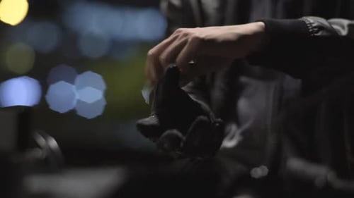 Motorcycle Rider Wearing And Testing His Gloves