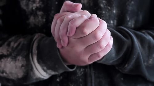 man praying to god with hands together Caribbean man praying with black background stock footage