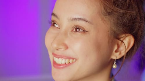 Joyful smiling woman indoor setting portrait photography vibrant lighting close-up positive emotions