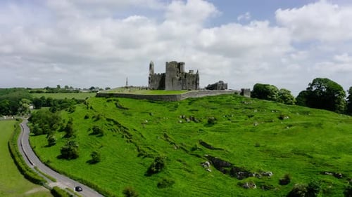 Drone shot approaching Ireland's Rock of Cashel, looking out over the countryside.