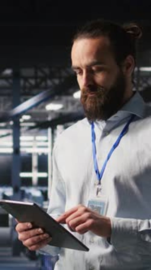 Vertical Video Cheerful Data Center Admin Doing Maintenance Tasks on Tablet