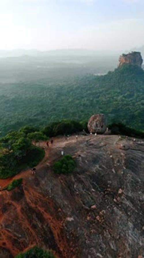Les touristes regardent le coucher de soleil depuis le temple rupestre royal de Pidurangala au Sri Lanka.
