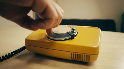 Retro Vintage Phone A Yellow Rotary Telephone is Displayed on a Wooden Desk Adding a Nostalgic Touch