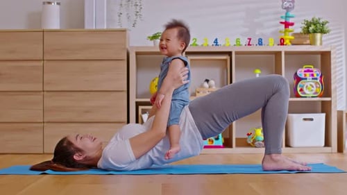 Mother Does Glute Bridge Exercise With Baby