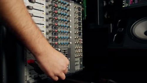 close-up of control buttons of a mixing console for recording soundtrack in a recording studio
