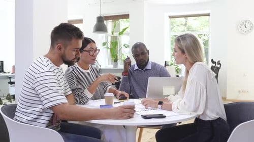 Diverse Team Discussing Business Around Table