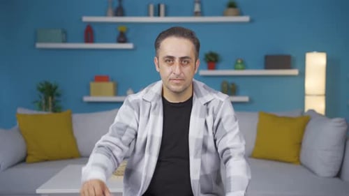 Man looking at camera with a negative expression.