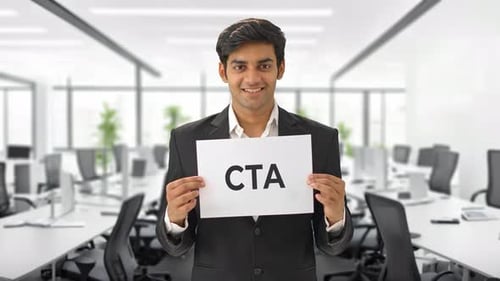 Young Adult Businessman Holds CTA Sign in Open Office