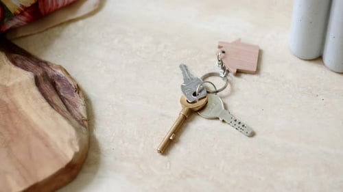 The House Keys are Slid Across the Surface - Close Up