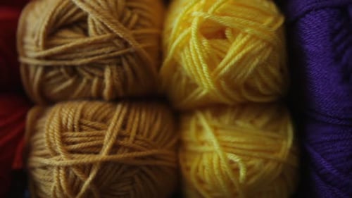 Vibrant balls of wool stacked in a calgary alberta yarn store display