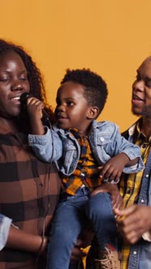 Vertical Video African American Mom and Dad Teaching Their Son How to Sing in Studio