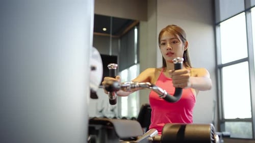 Woman Working Out at Gym with Exercise Machine