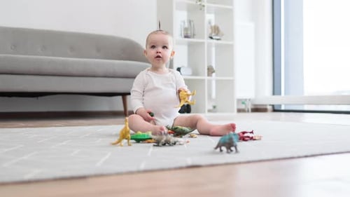 Infant Playing with Dinosaur Toys on Carpet