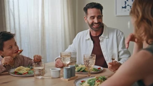 Family Enjoys Pasta Meal Together at Home
