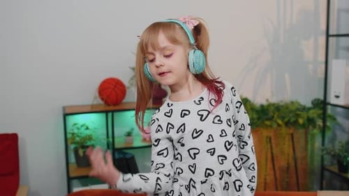 Girl Dancing with Headphones at Home