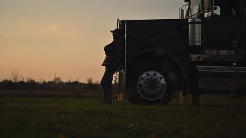 Caucasian Trucker and His American Semi Truck Tractor