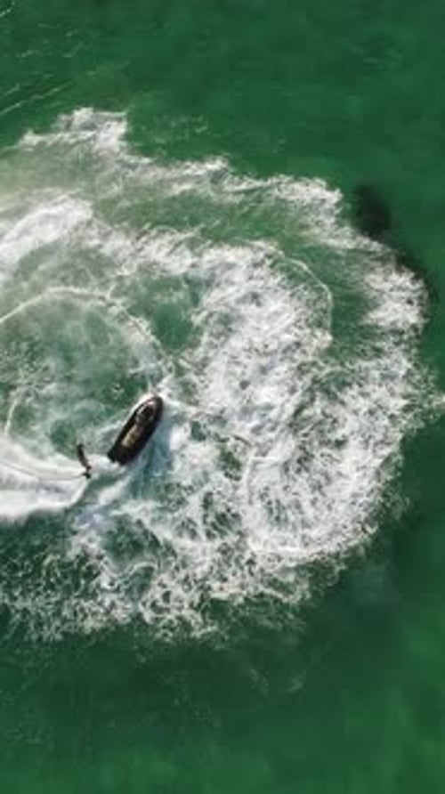 A Man Flies on a FlyBoard Aerial Top Down View Water Extreme Sport Azure Summer Sea with Outdoors