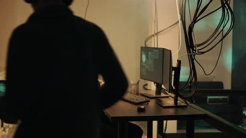 Young Adult Using Virtual Reality Headset at Desk