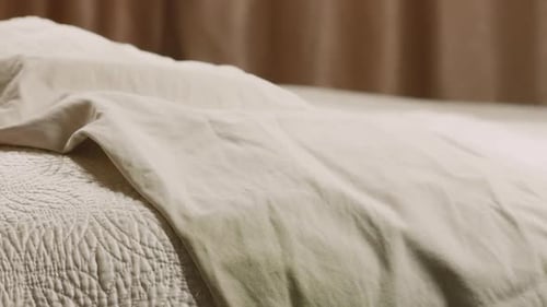 Clothes Dropped Onto Bed in Bedroom